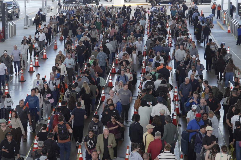 Travelers line up at a TSA checkpoint at George Bush Intercontinental Airport in Houston
