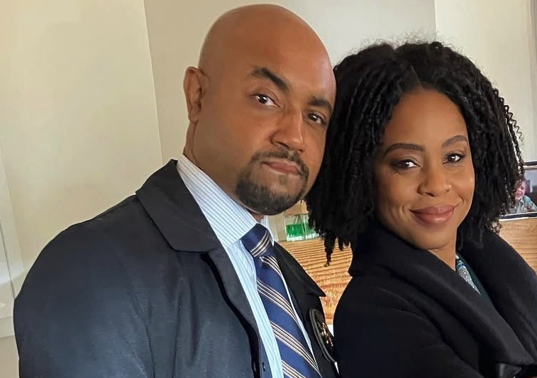 Man in suit next to woman in suit