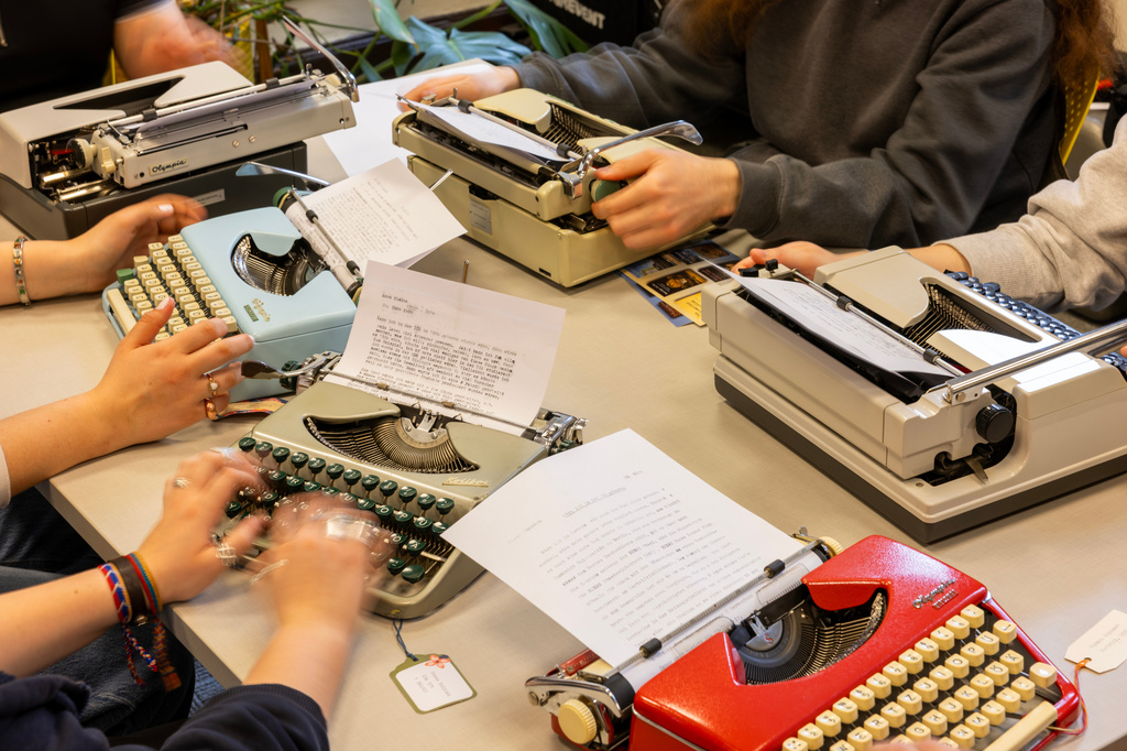Students use typewriters to complete a writing assignment