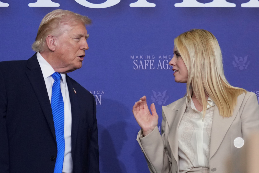 President Donald Trump speaks with Attorney General Pam Bondi during a roundtable discussion on public safety at a Tennessee Air National Guard Base in Memphis