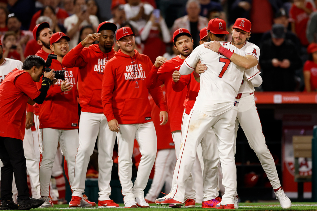 Los Angeles Angels Jo Adell (7) is greeted by teammates at the end of a baseball game against the Seattle Mariners