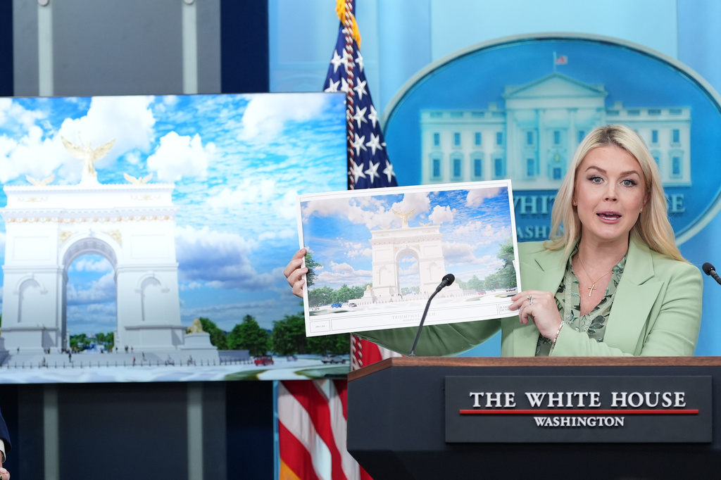 White House press secretary Karoline Leavitt holds up an artist rendering of the new triumphal arch 