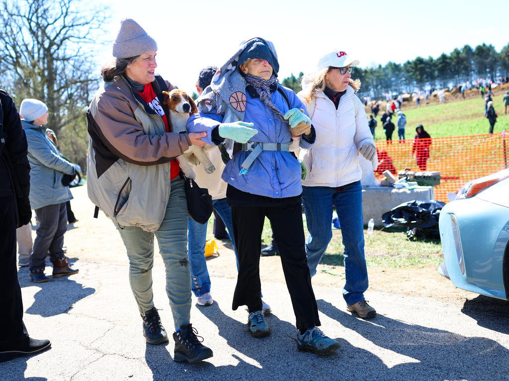 Activists help an elderly woman after she had been tear gassed during an attempt to gain entry into Ridglan Farms beagle breeding and research facility 