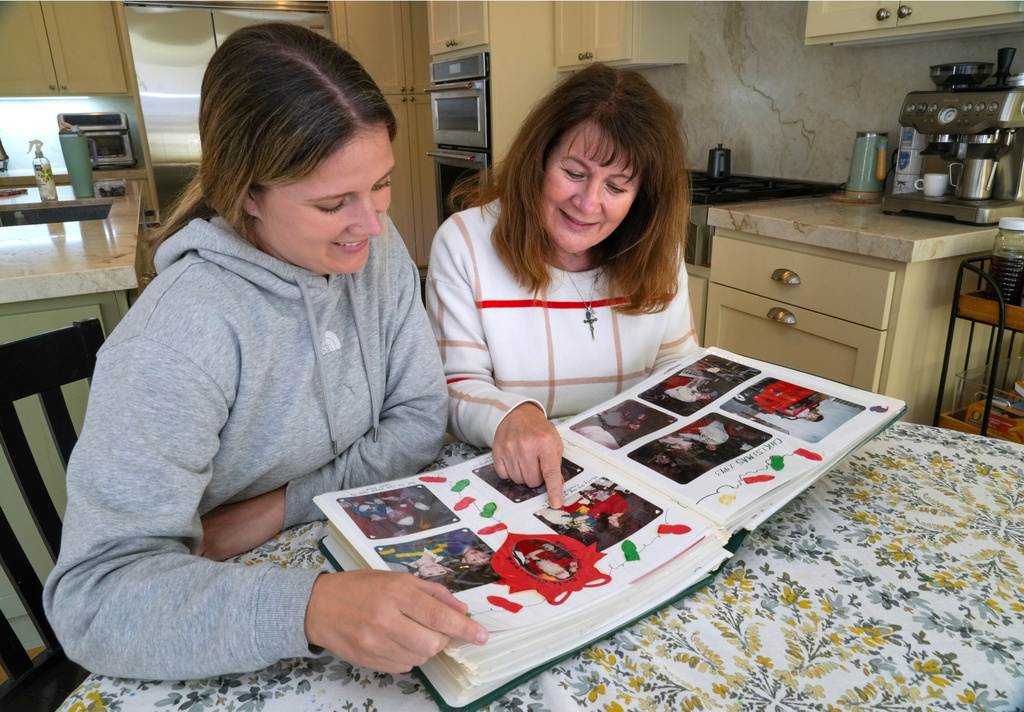 Kelley Nalewaja, right, looks over photos of her son, Michael Nalewaja, who died after unknowingly taking a lethal cocktail of fentanyl and carfentanil