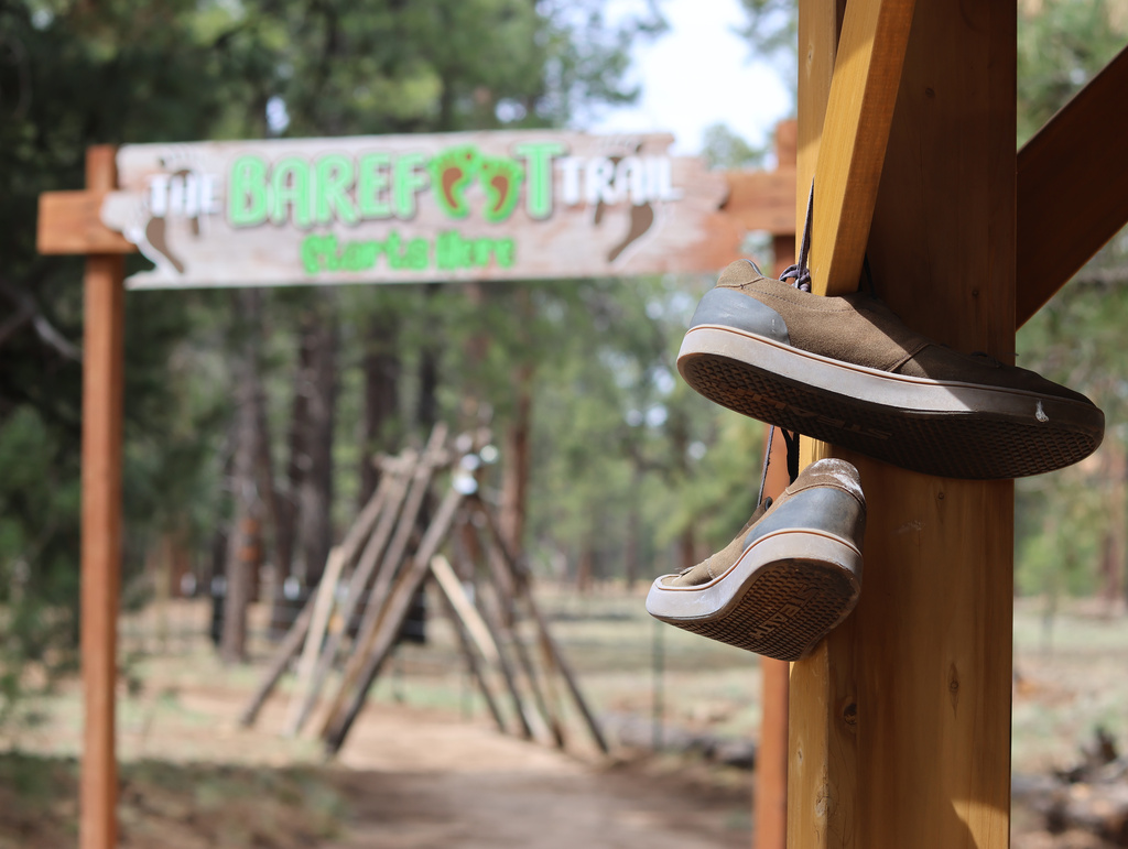 Shoes hang near the entrance of a barefoot trail near Flagstaff, Ariz.