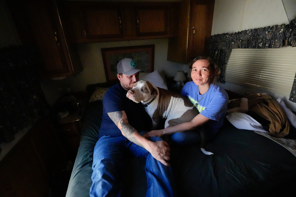 Michael Gibson and his fiancée Tabitha Enke sit inside their camper after losing their home during the Brantley Highway 82 fire, Friday, April 24, 2026, in Nahunta, Ga. 