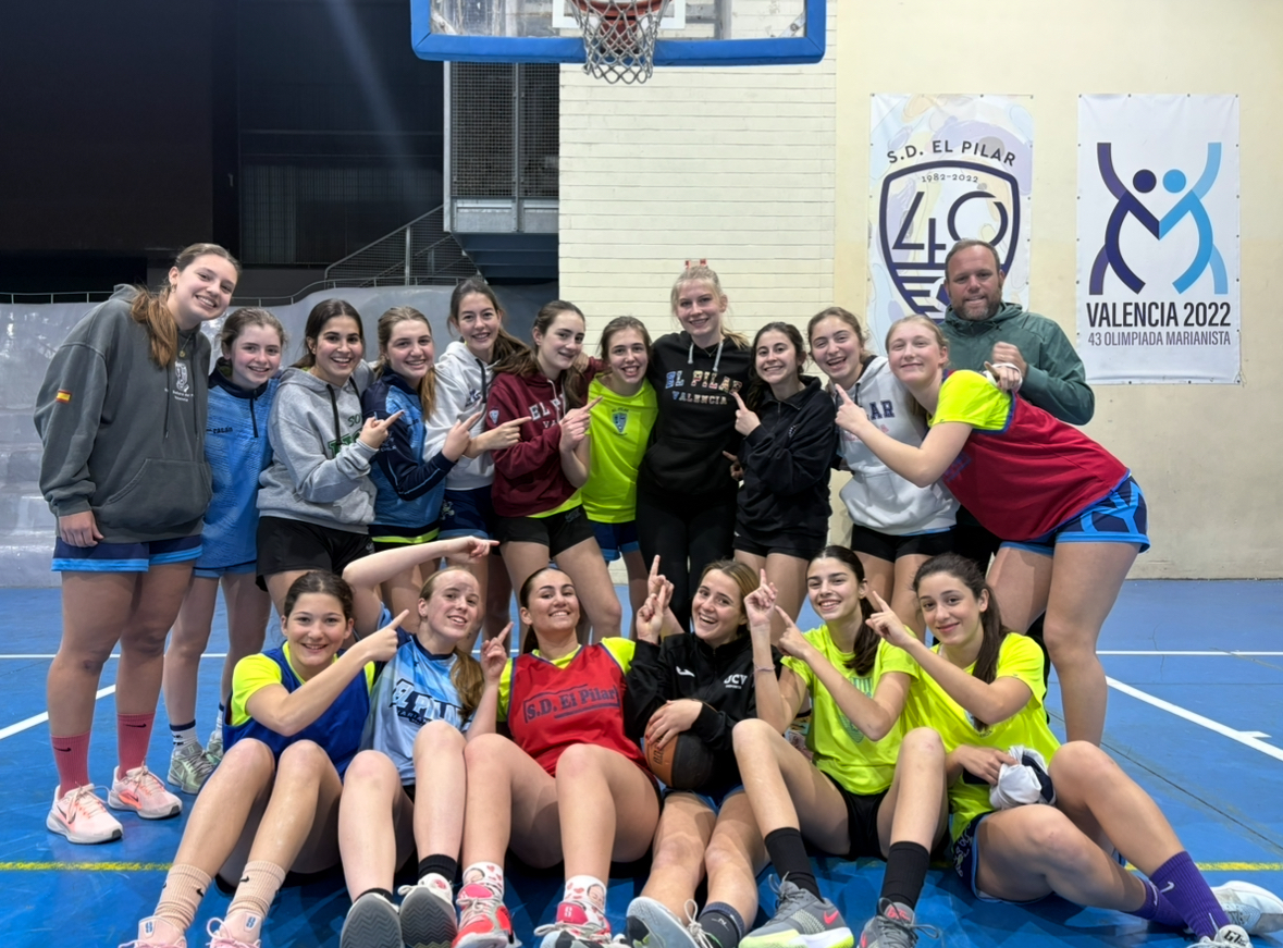 Cedarville University senior Cassi Shields (center, black hoodie) poses with a girls basketball team in Valencia, Spain, where she leads strength and conditioning sessions as part of her internship.     