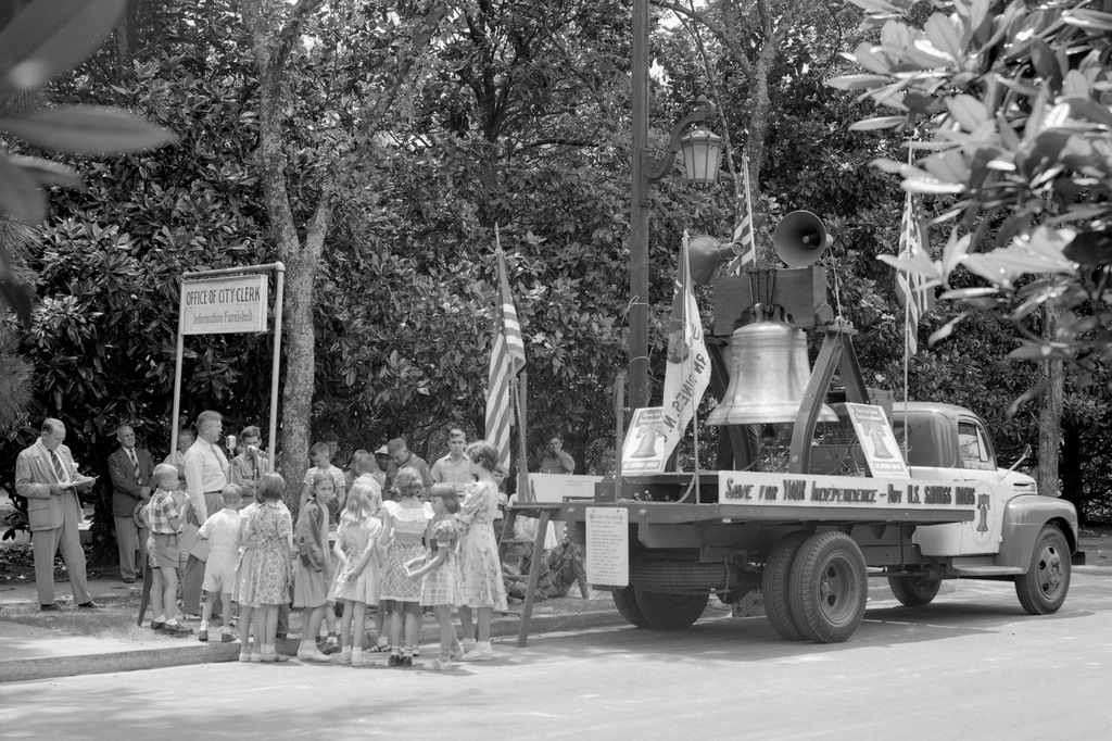 1950s: People stand around a flatbed truck with a replica of the Liberty Bell mounted to it during a savings bond drive in North Carolina
