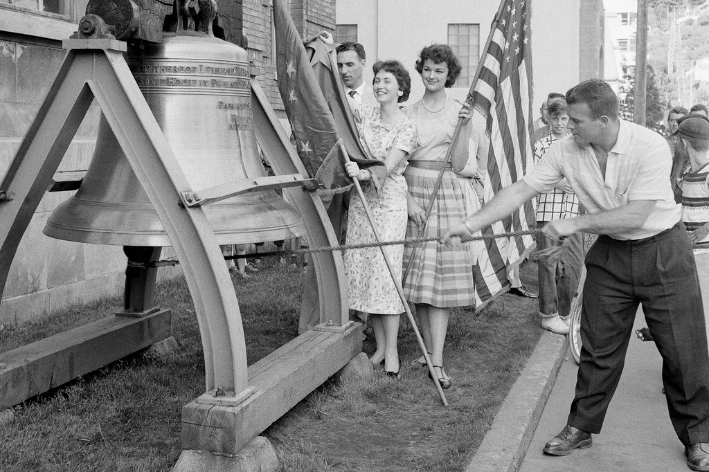 Romer Derr rings a replica of the Liberty Bell outside the Federal Building 49 times, signifying Alaska