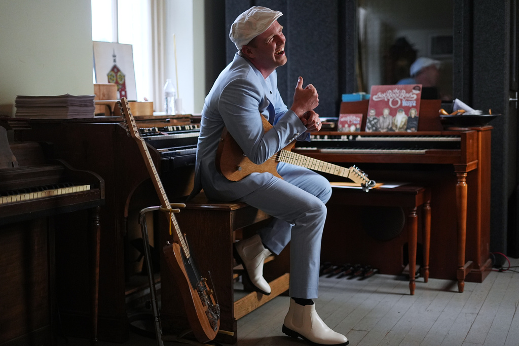 Conrad Fisher laughs during an interview with the Associated Press ahead of his performance at Ragamuffin Hall 