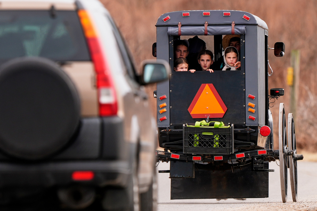 Amish youngsters ride in the kid box of a buggy Sunday, March 8, 2026, in Lancaster County, Pa. 