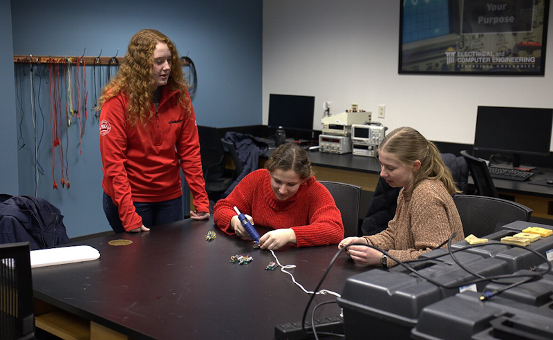Abigail Nutter (left), SEAM secretary, builds solar lights with Stephanie Stubblefield (middle), a junior mechanical engineering student from Tucson, Arizona, and Abigail Haut (right), a sophomore computer engineering student from Kankakee, Illinois