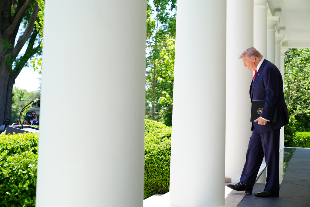 President Donald Trump walks through the Colonnade at the White House