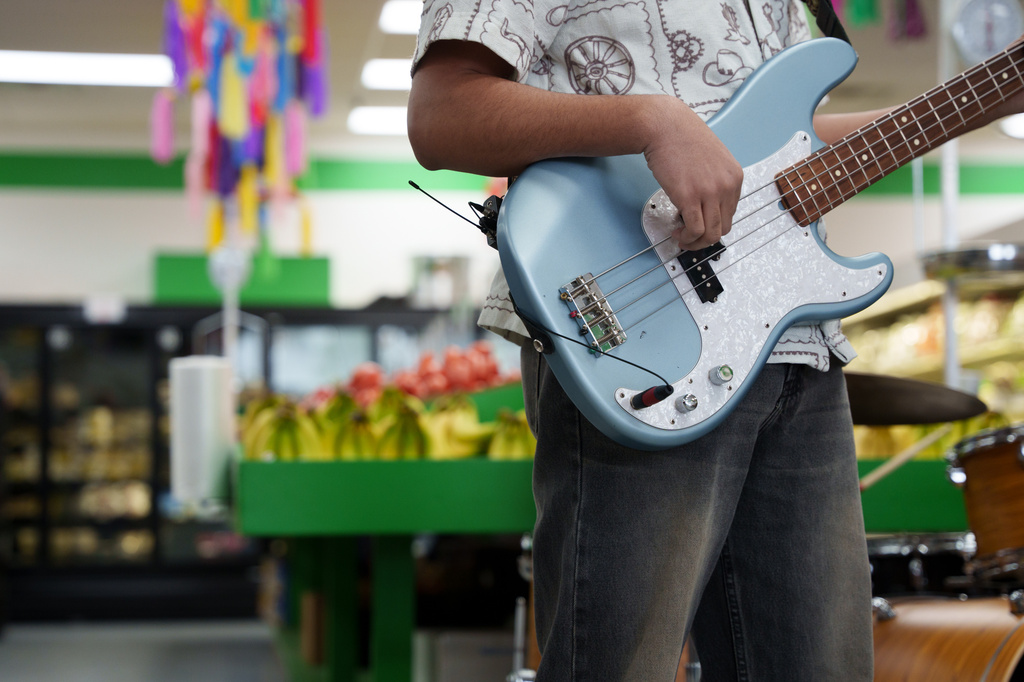 Guitarist performs in the produce section of Fiesta Fresh Market in New Castle, Del.