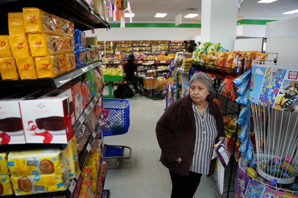Customer shops while a band plays in the background in New Castle, Del.