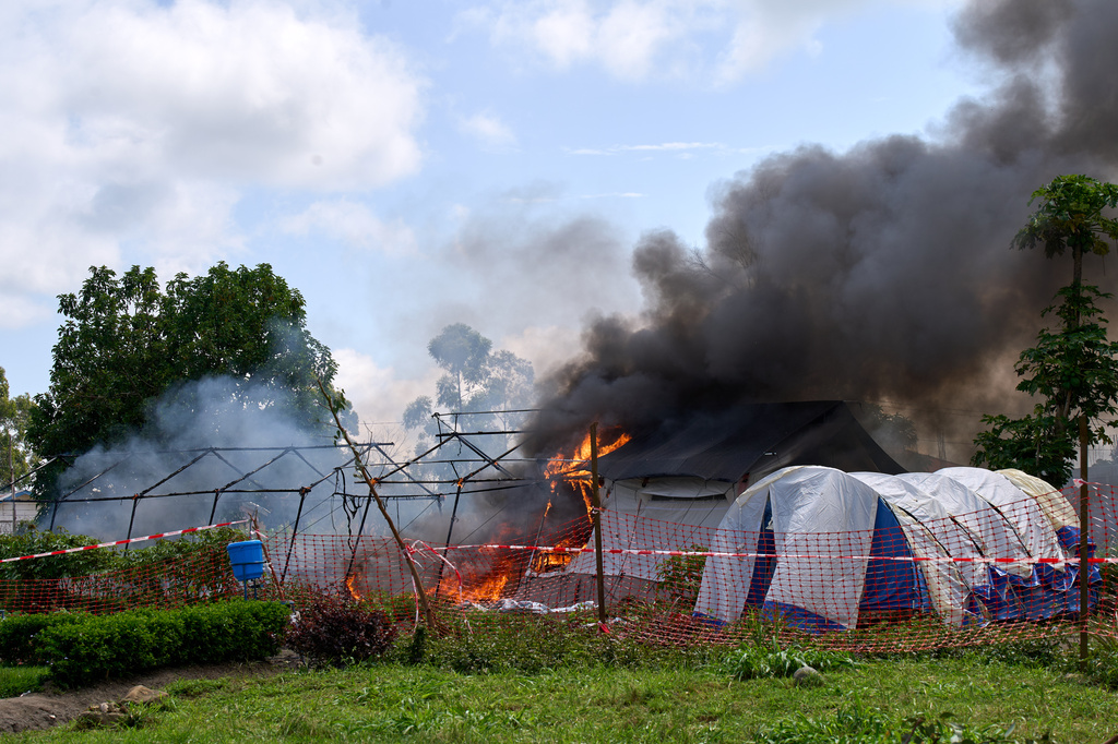 Flames and smoke rise from an Ebola treatment center in Rwampara, Congo