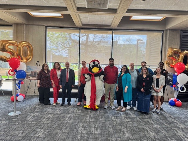 Youngstown State University mascot, Pete the Penguin, was among the attendees who gathered to celebrate the 50th anniversary of Maag Library.