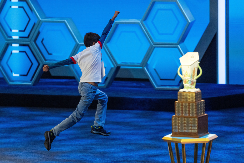 Sanil Thorat, 10, of Shreveport, La., reacts after answering correctly during the quarterfinals of the Scripps National Spelling Bee