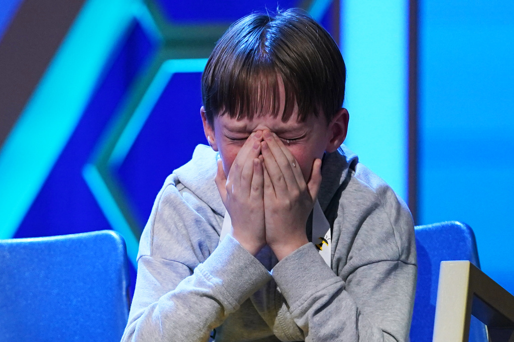 Logan Bailey, 12, of Houston, Texas, reacts during the final round of the 2026 Scripps National Spelling Bee in Washington