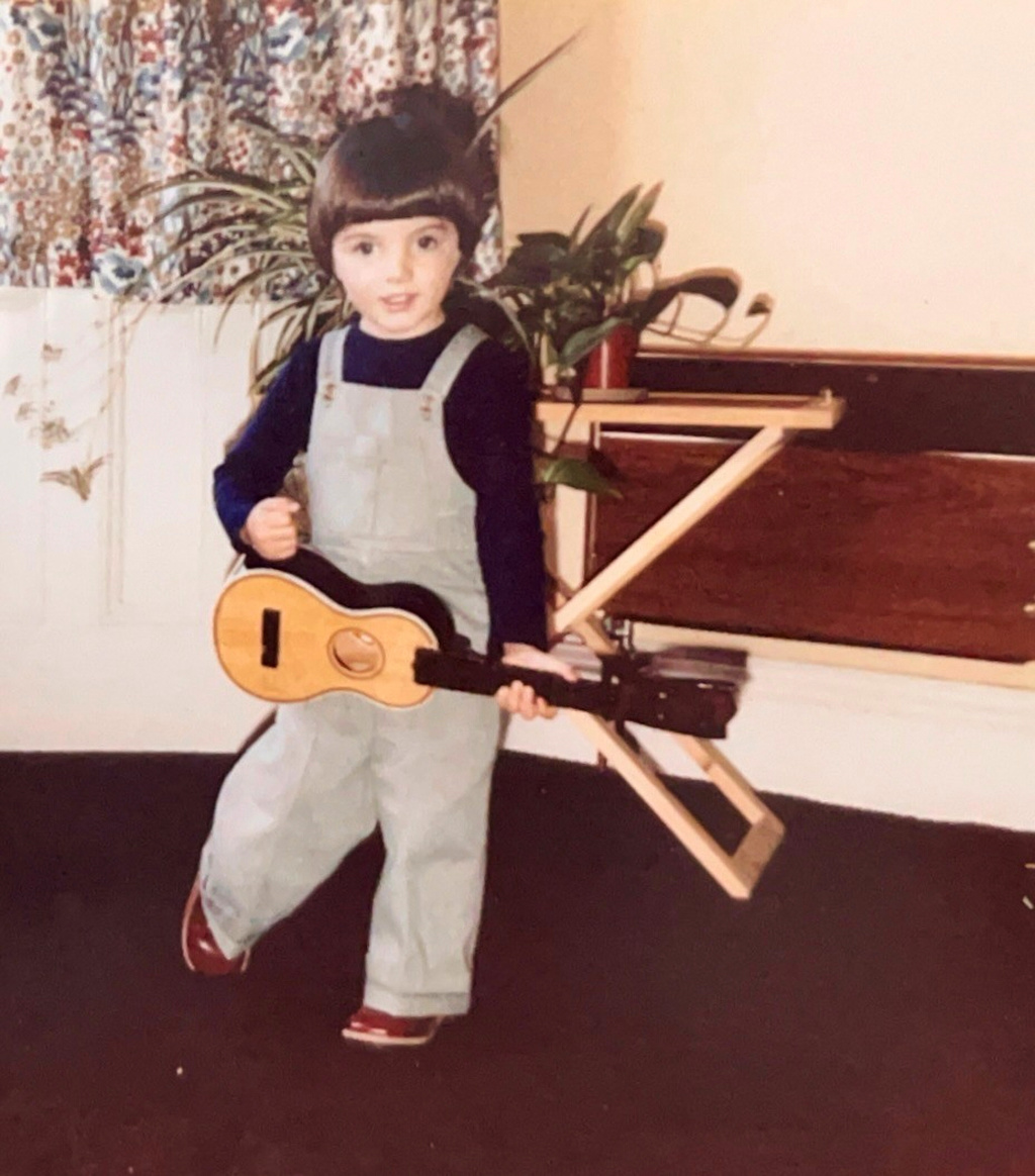 Samuel Smith as a young child with a toy guitar