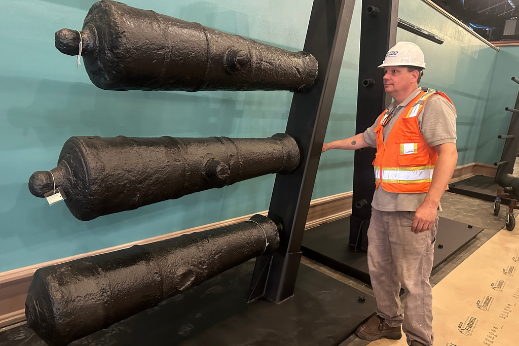 Terry Koeller inspects cannons, which sunk to the bottom of the Savannah River during the American Revolution, on a rack at the Savannah History Museum 