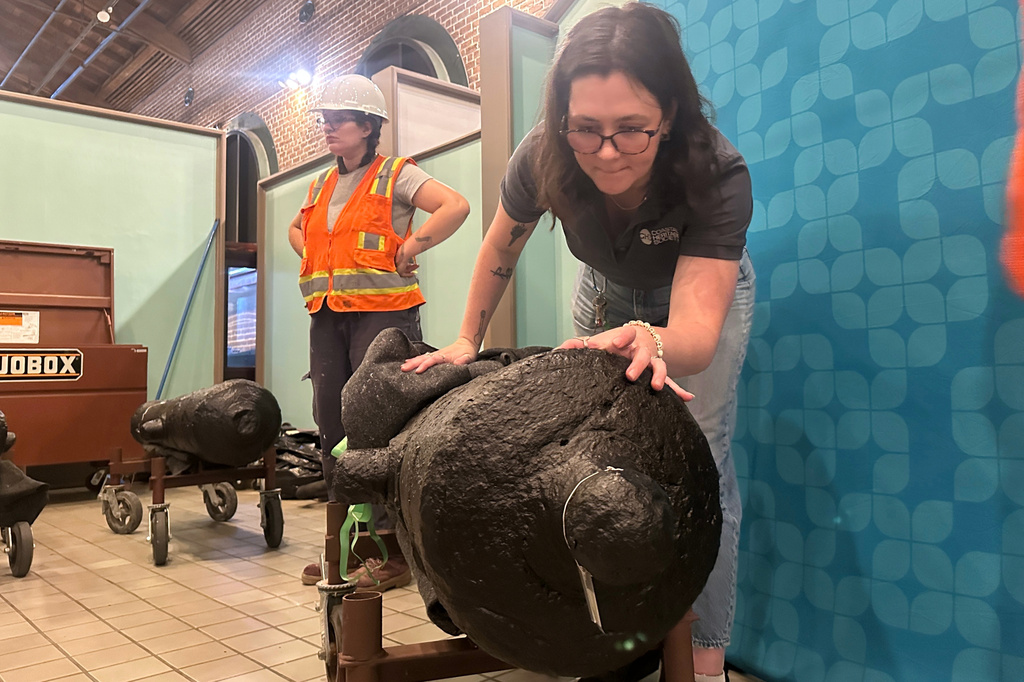 Samantha Moss inspects a cannon, which sunk to the bottom of the Savannah River during the American Revolution
