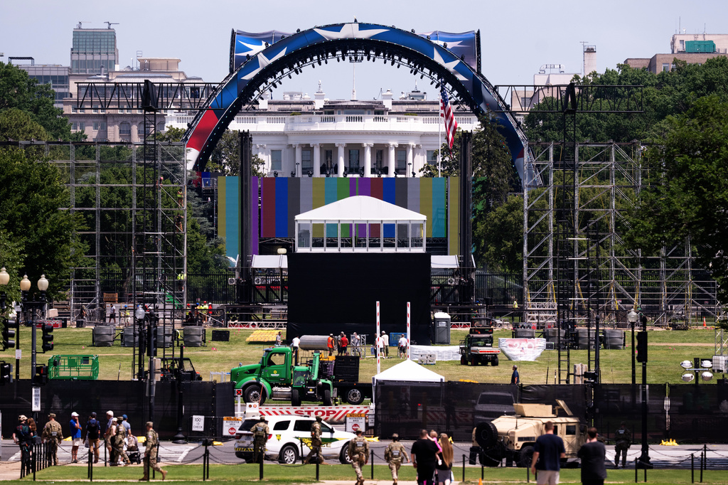 Workers continue building the cage for a future UFC fight on the South Lawn in front of the White House