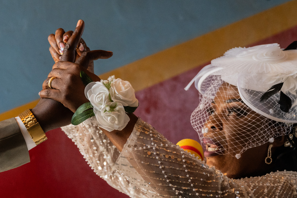 A bride puts a ring on the groom