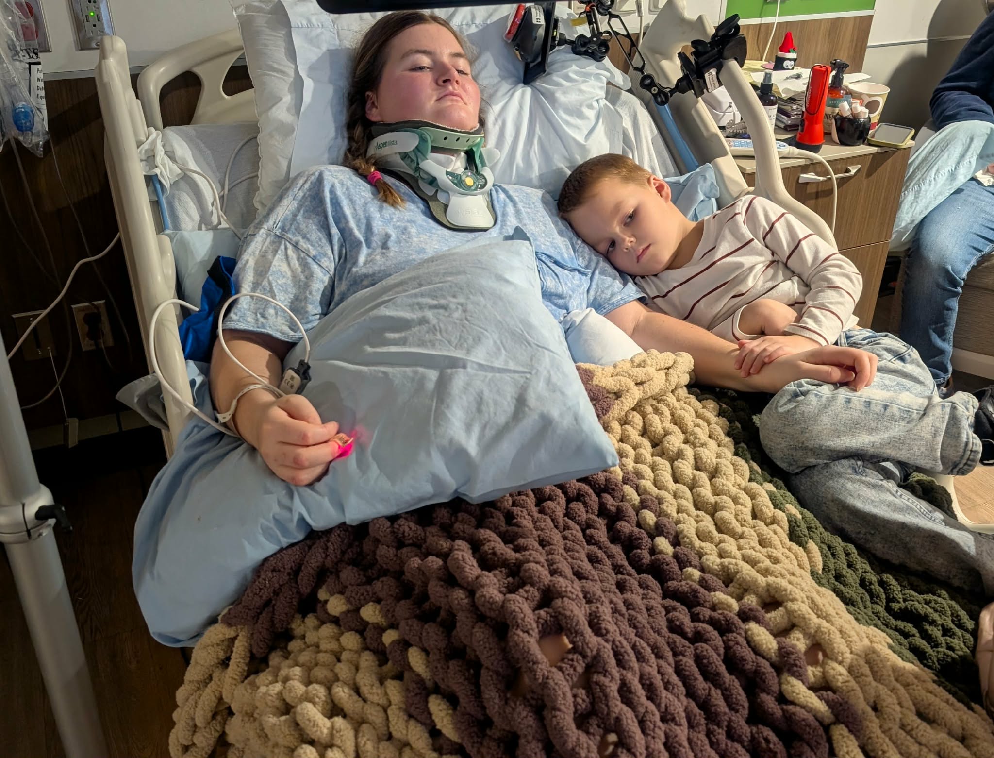 Madison and her son Miller, laying in a hospital bed together as she recovers.
