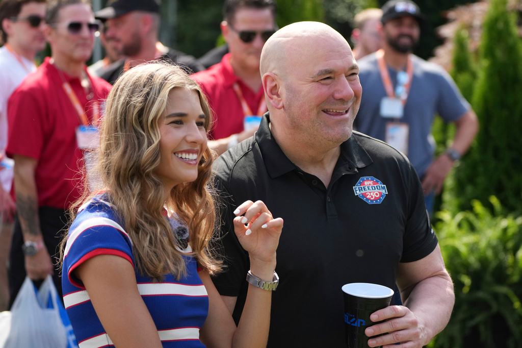 Kai Trump, left, and UFC President and CEO Dana White looks on before a Motorsports athlete and stunt performer does a motorcycle jump ahead of the UFC Freedom 250 fights