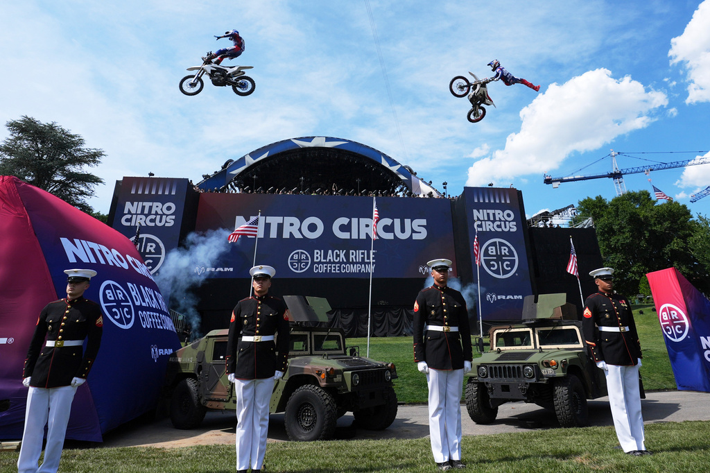 Motorsports athletes and stunt performers do a motorcycle jump ahead of the UFC Freedom 250 fights on the South Lawn of the White House