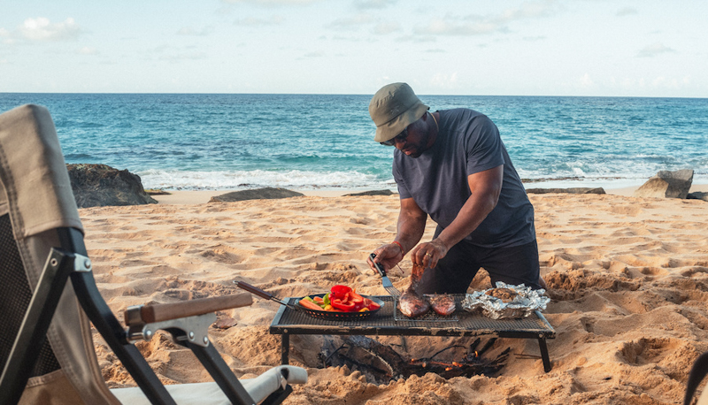 Rashad Frazier prepares food on a beach on Manatí, Puerto Rico