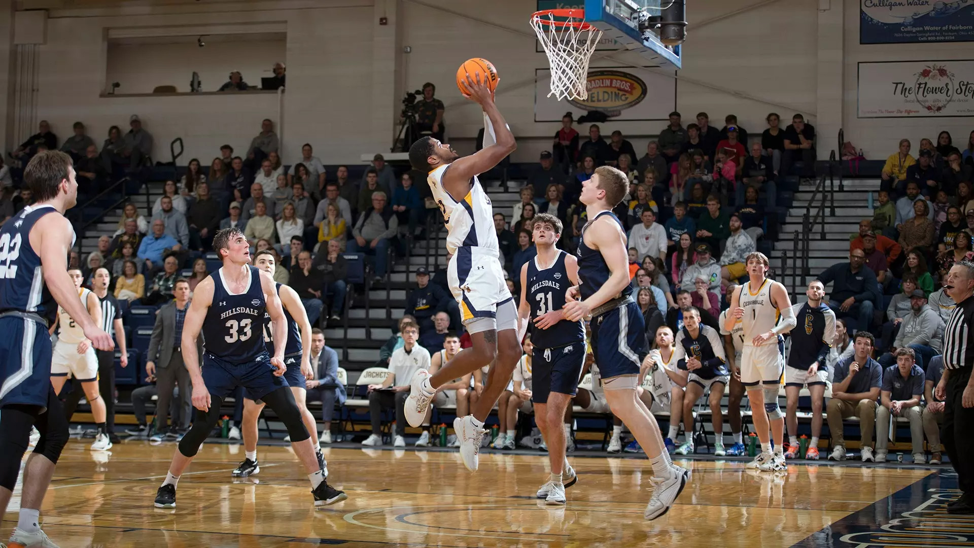 Athletes compete during a collegiate basketball game