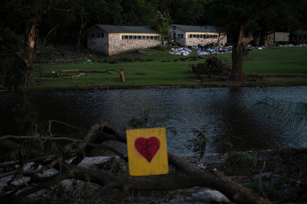 A broken heart sign is displayed near Camp Mystic on Tuesday, July 8, 2025, after a flash flood swept through the area 