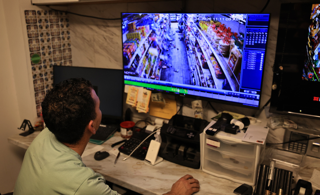 Redwood Valley Market owner Alex Chehada watches his closed circuit feed showing the time when an earthquake struck in Redwood Valley, Calif.