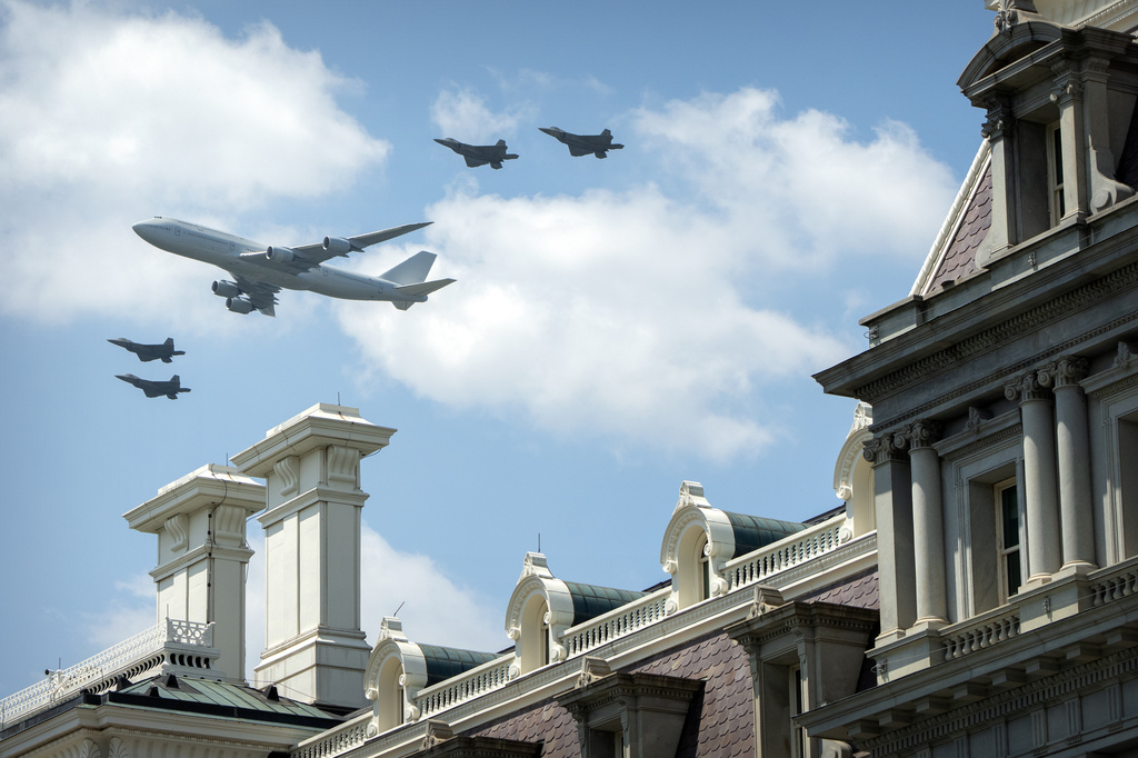 Military aircraft fly over the National Mall near the Eisenhower Executive Office Building 