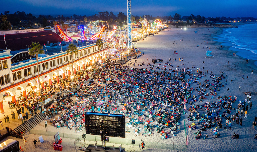 Fans watch a broadcast of the World Cup Group D soccer match between the United States and Turkey at the beach boardwalk in Santa Cruz, Calif.