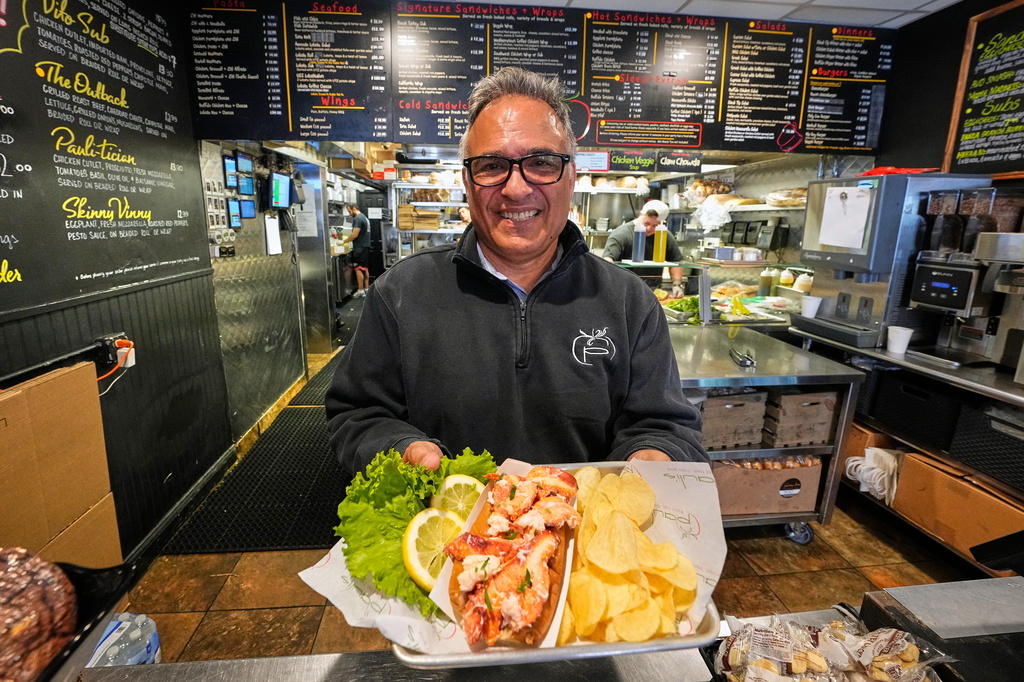 Paul Barker serves lobster rolls to World Cup tourists at Pauli