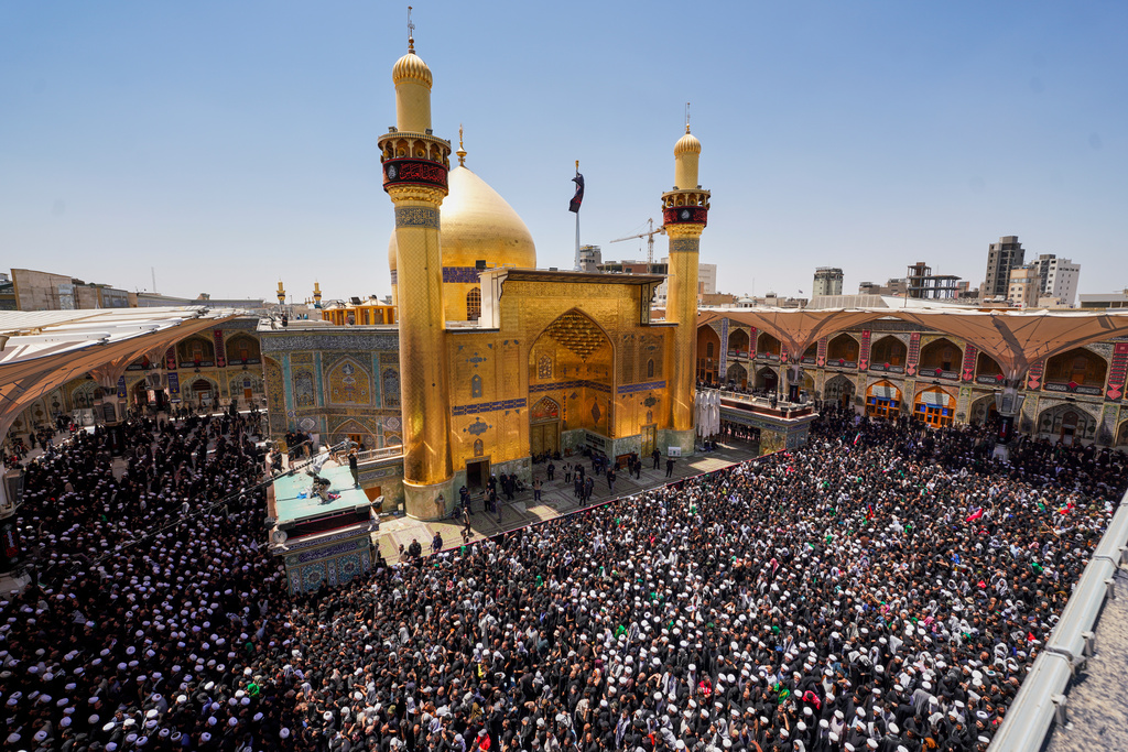 Mourners gather in prayer during the funeral procession for the late Iranian Supreme Leader Ayatollah Ali Khamenei inside the Imam Ali Shrine in Najaf, Iraq