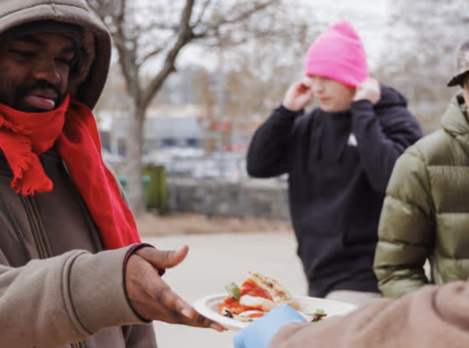 Man receiving a slice of pizza