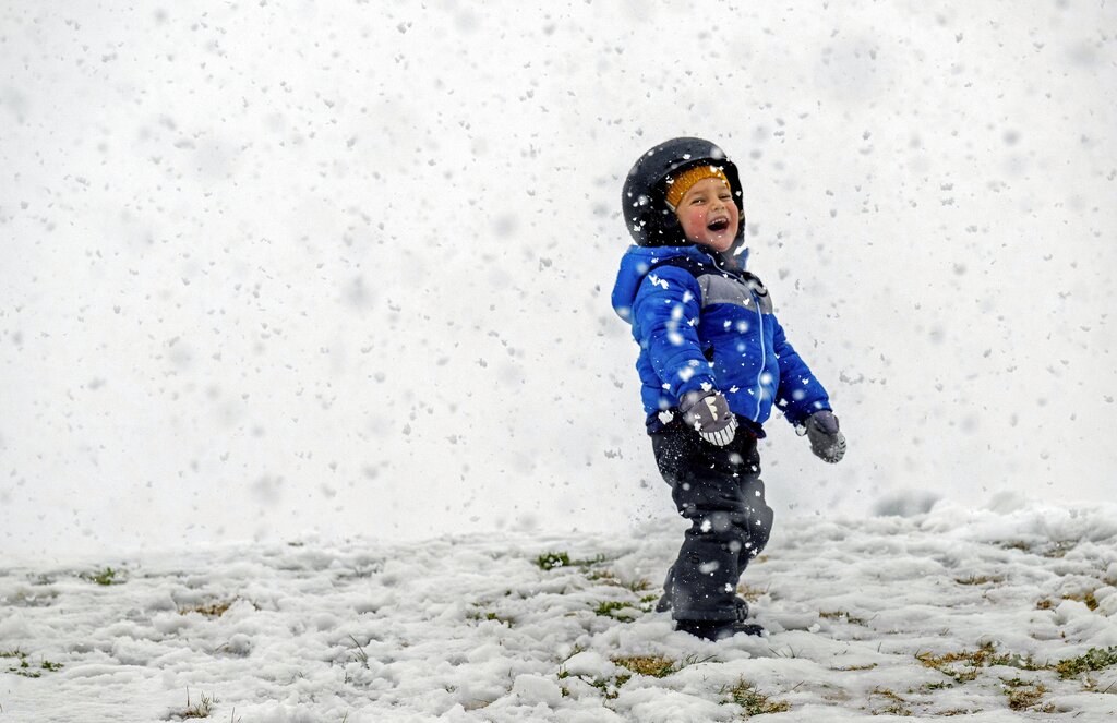 Kamal Rahm,3, of Carlsbad, enjoys the snow at Yucaipa Community Park in Yucaipa, Calif.