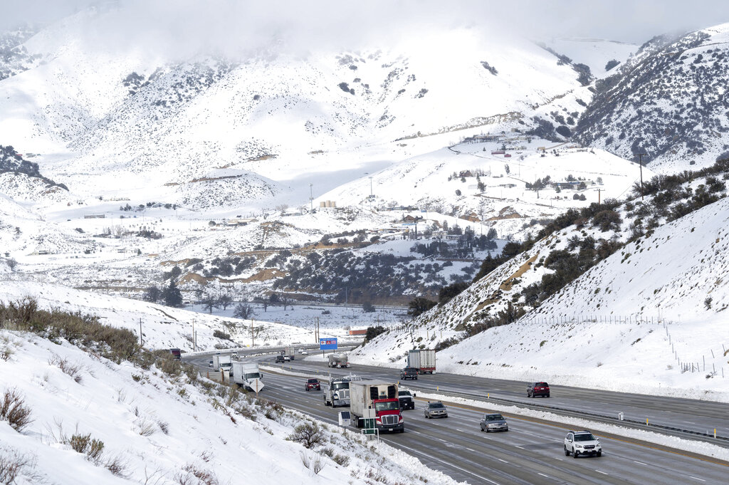Snow surrounds the I-5 freeway through Gorman, Calif. in Southern California