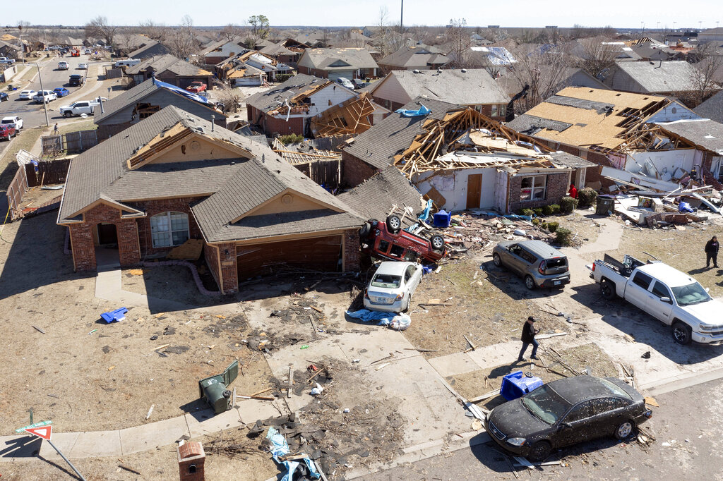 Residents assess damage along Conway Drive in Norman, Okla.