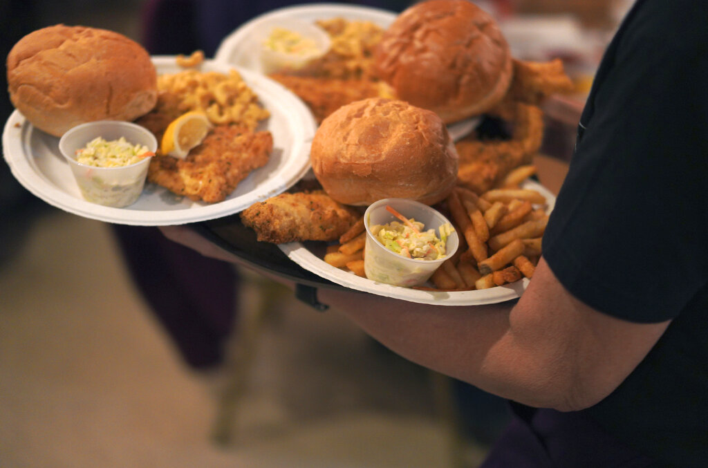 Plates of fried fish and sides are delivered at the Allegheny Elks Lodge #339 during their annual fish fry on the first night of Lent, in Pittsburgh