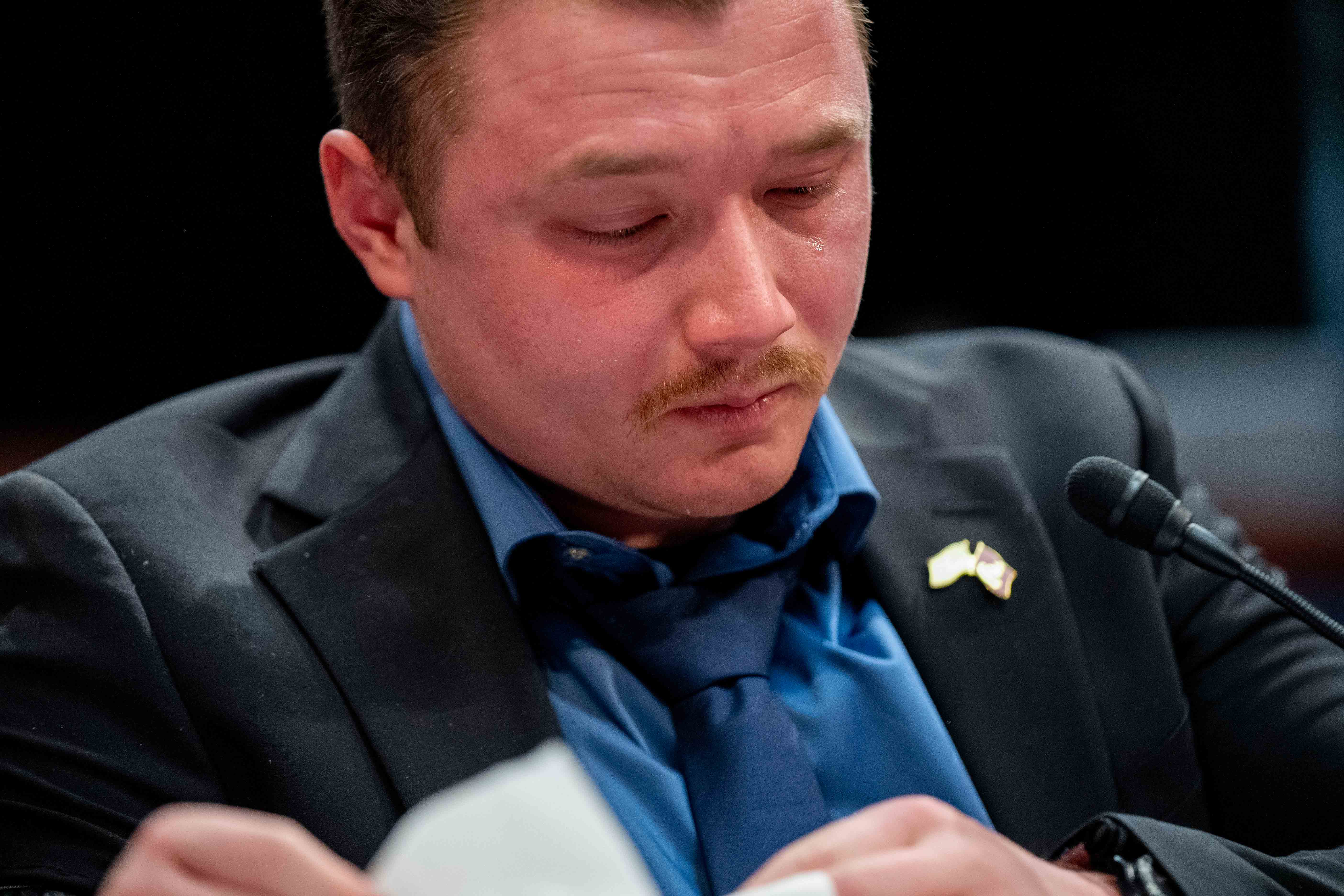 Former Marine Sgt. Tyler Vargas-Andrews, who was gravely injured, losing an arm and a leg in a suicide attack at Hamid Karzai International Airport in Kabul, becomes emotional as he recounts his story during a House Committee on Foreign Affairs hearing on the United States evacuation from Afghanistan on Capitol Hill in Washington, Wednesday, March 8, 2023.