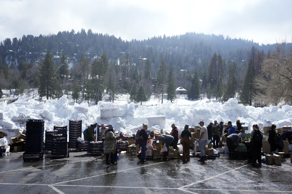 Food is distributed out of a parking lot after a series of storms in Crestline, Calif.