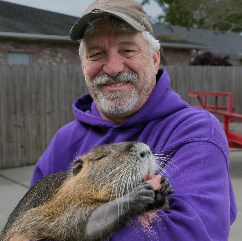 Denny Lacoste holds a rescued baby nutria in Metairie, La.