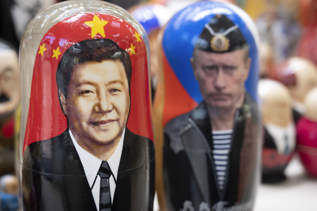 Russian matryoshka dolls with portraits of Chinese President Xi Jinping, left, and Russian President Vladimir Putin are displayed among others for sale at a souvenir shop in Moscow