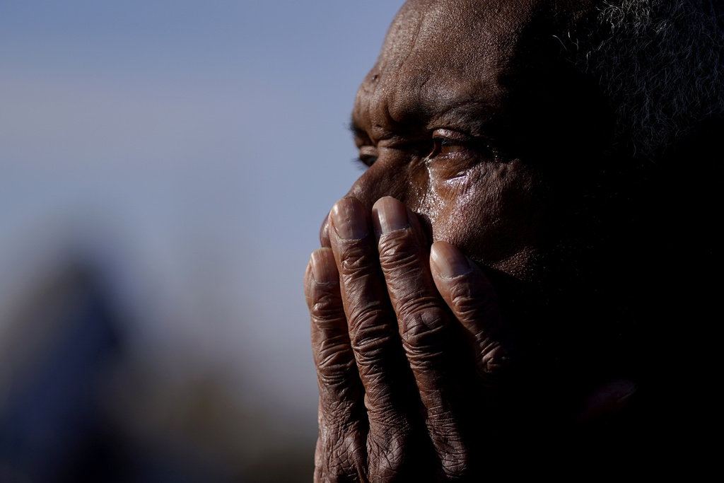 Ezell Williams cries while talking about the damage caused to his properties and those of his neighbors in Rolling Fork, Miss.