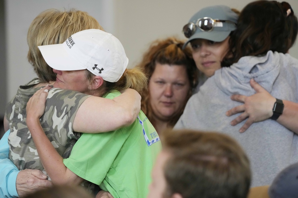 Members of the First Baptist Church of Rolling Fork, Miss., embrace before a Sunday morning service